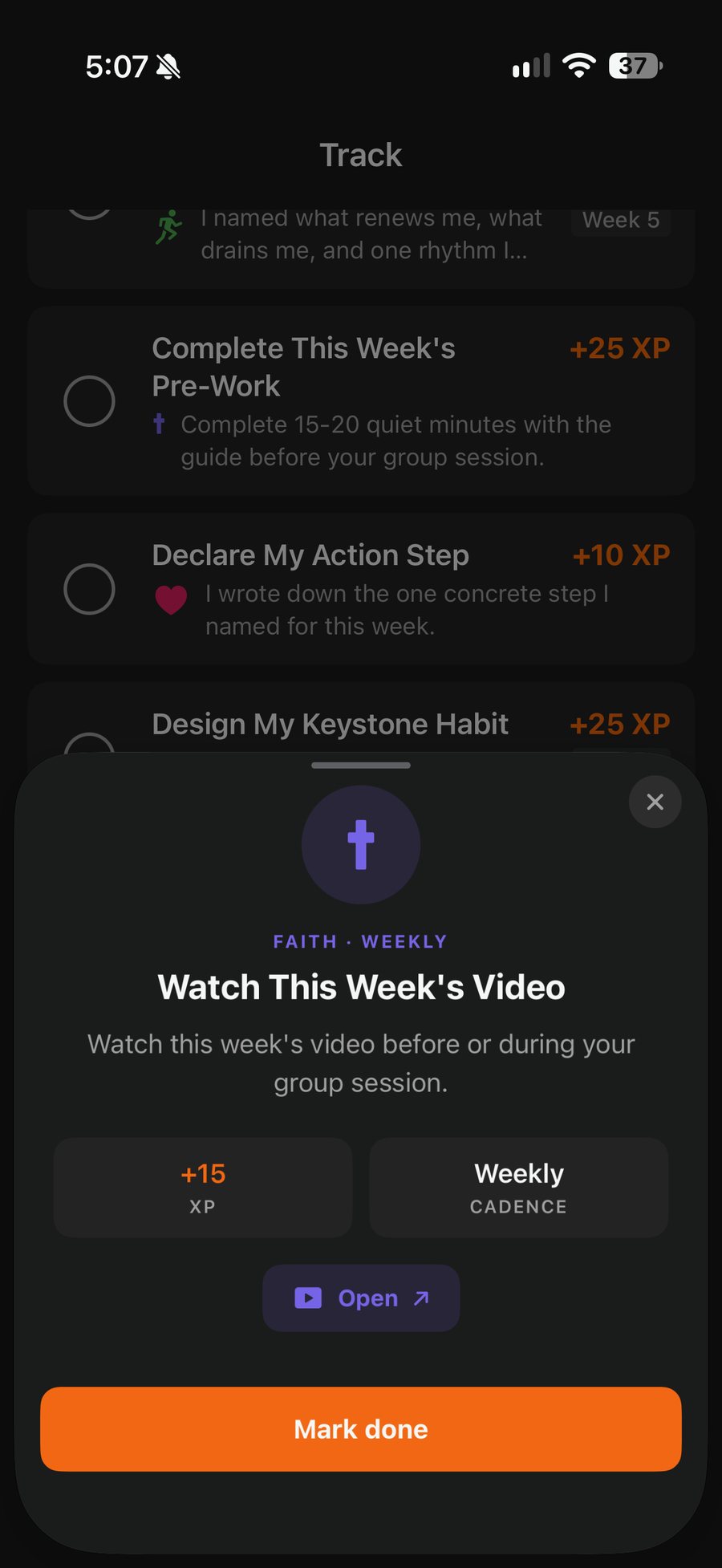 A task opened from Track: Faith, weekly, Watch This Week's Video, worth 15 XP, with an Open button for the video and Mark done